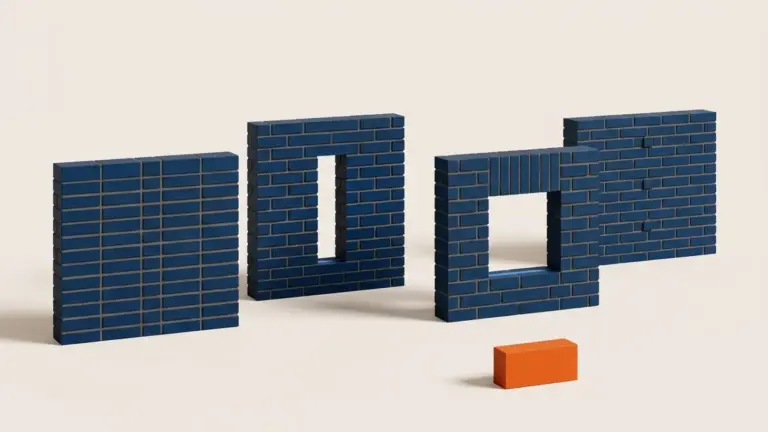 Four short free-standing sections of dark navy brickwork stand on a warm off-white ground plane. Each is the same height and length but laid in a different bond: plain flush coursing; running bond pierced by a narrow slot cut clean through; a run of square brick ends forming a soldier course over a square-headed opening; and tied headers keyed back through the depth. A single loose orange brick lies on its side in the foreground, the only orange in the frame.